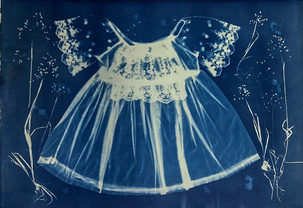 Cyanotype of baby dress and grasses